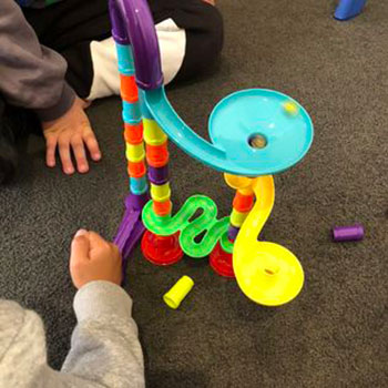 Children playing with colourful block slide