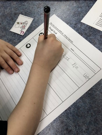 Child writing on worksheet